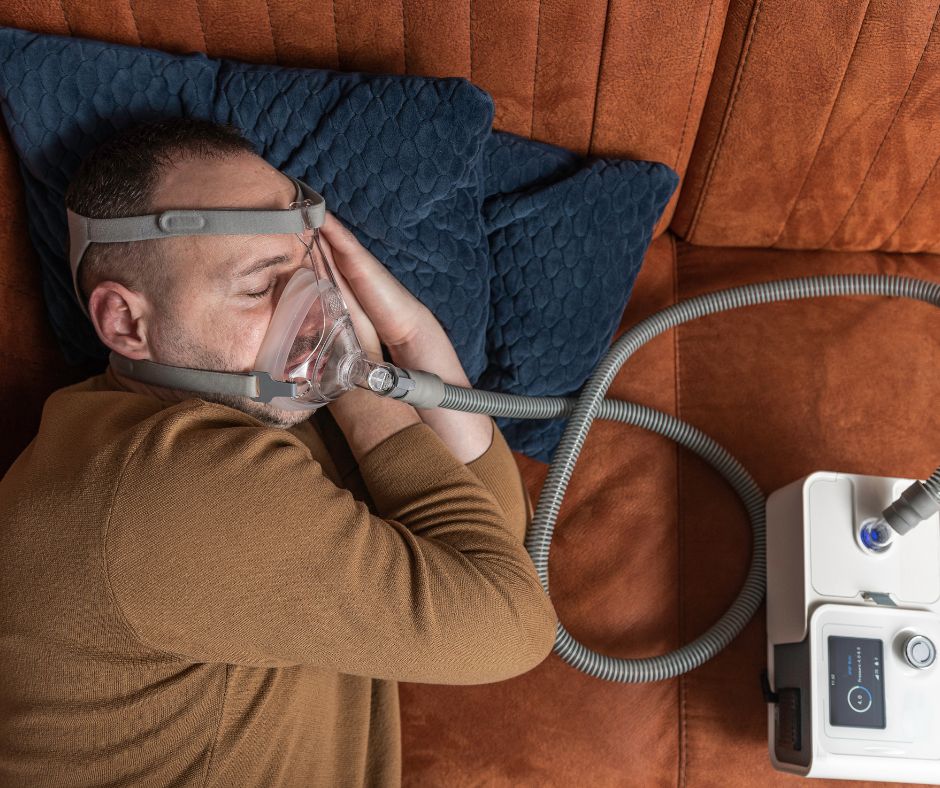 Person with sleep apnea using CPAP machine